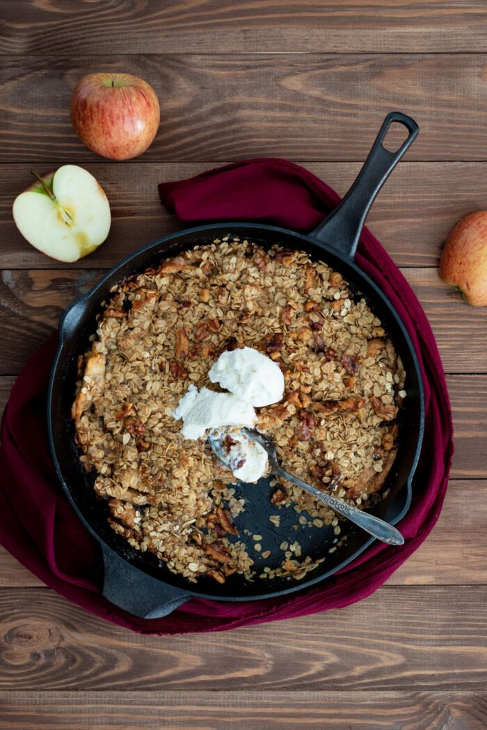 apple crisp with vanilla ice cream in a cast iron skillet