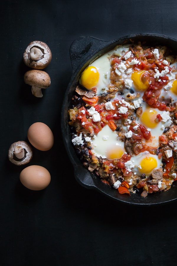 salsa, eggs, feta cheese in cast iron skillet with mushrooms and sausage