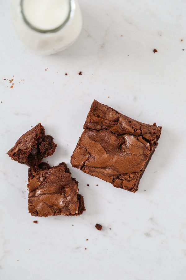brownies on marble with milk glass