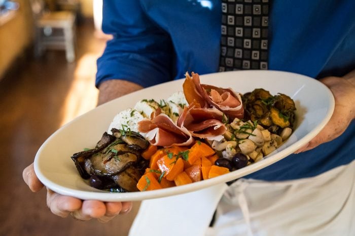 Server holding plate of food