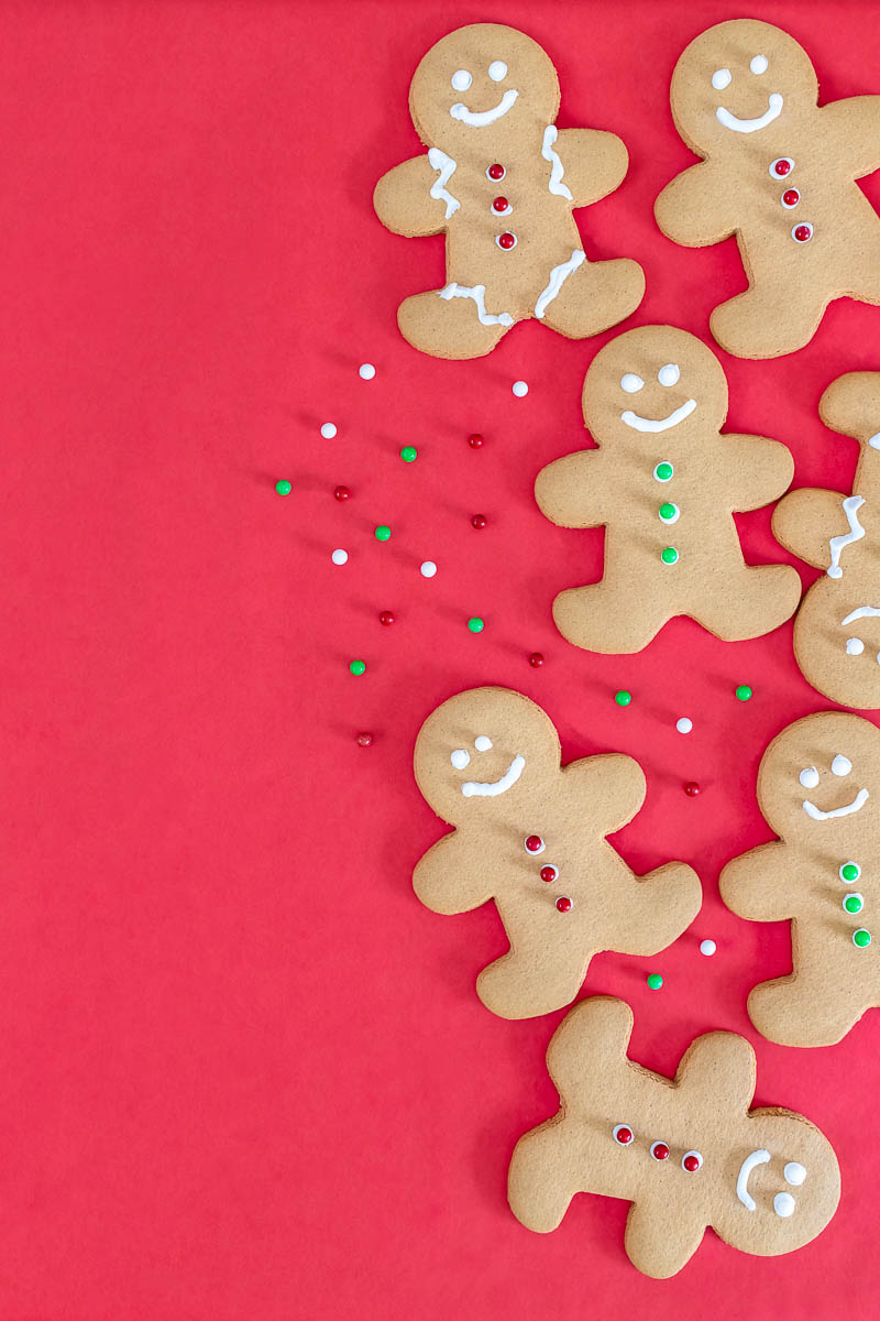 gingerbread cookies shaped as men with happy faces on a red background