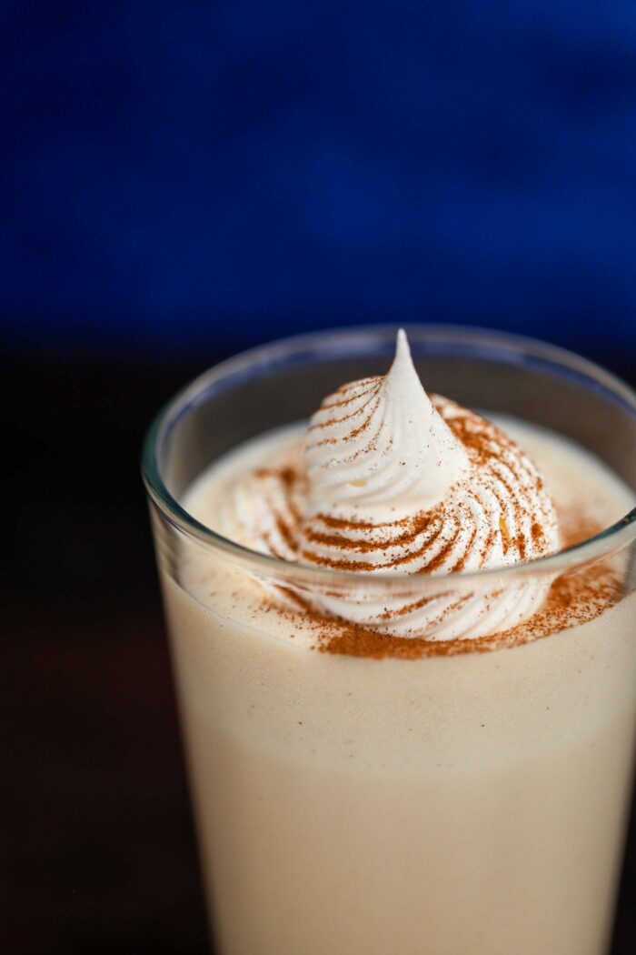 milkshake in glass with whipped cream and spices