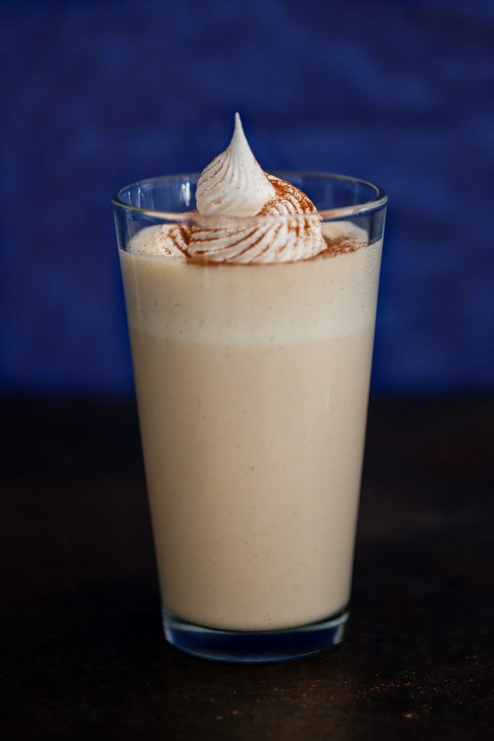 milkshake in glass with whipped cream and spices