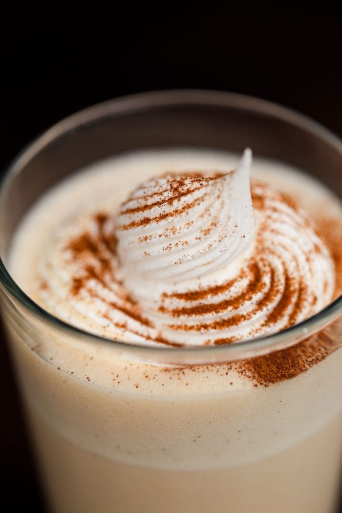 milkshake in glass with whipped cream and spices