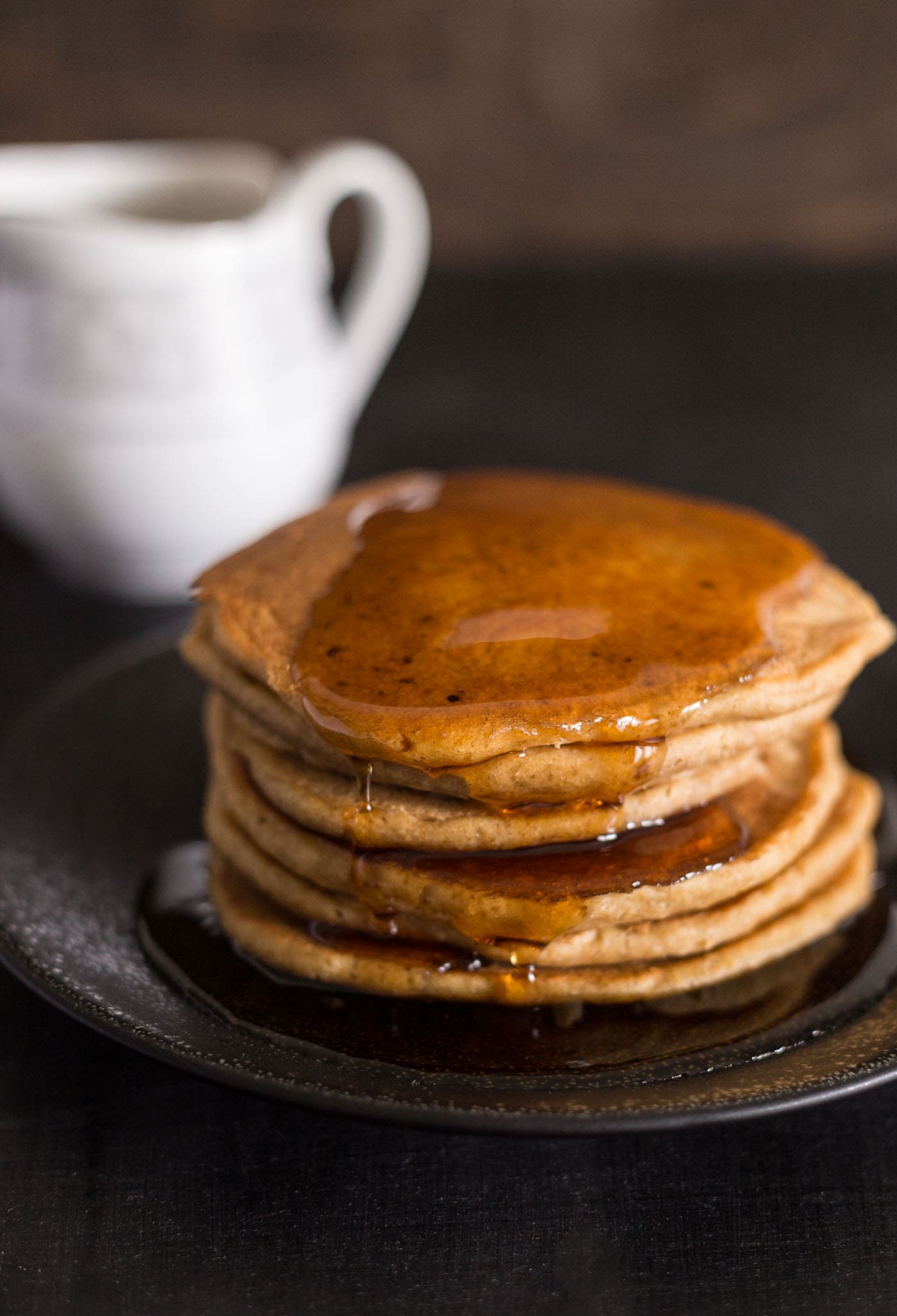 Stack of pumpkin spice pancakes with syrup